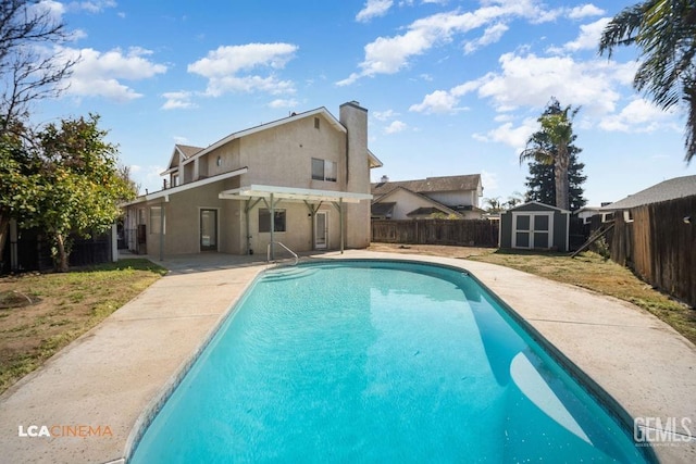 view of swimming pool featuring a fenced in pool, a patio, a storage unit, a fenced backyard, and an outdoor structure