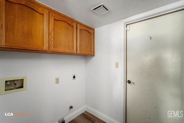 laundry area with cabinet space, baseboards, visible vents, wood finished floors, and hookup for a washing machine