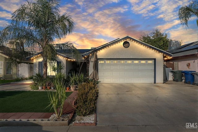 view of front of property featuring solar panels and a garage