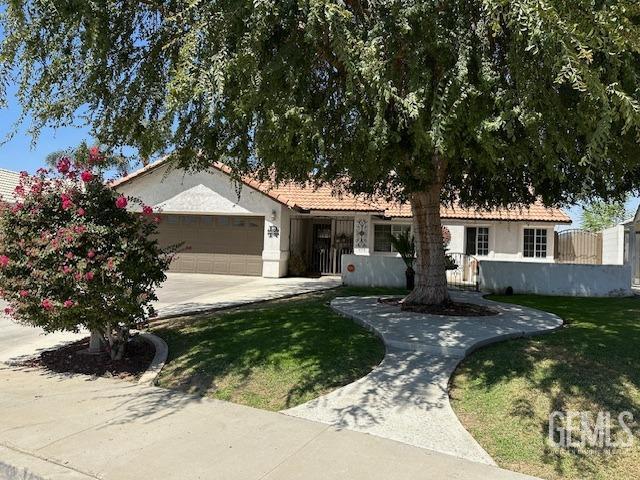 ranch-style house with a garage and a front yard