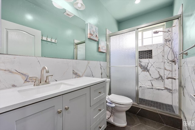 200 Justin Ct, Shafter, CA 93263 - bathroom with a marble finish shower, vanity, tile walls, tile patterned flooring, and wainscoting