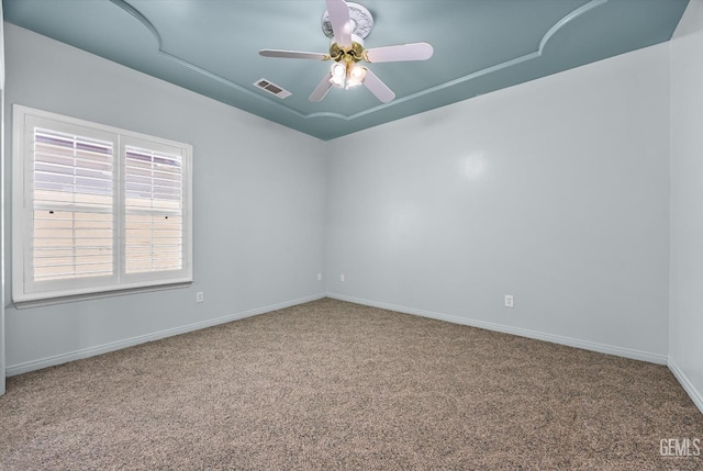 200 Justin Ct, Shafter, CA 93263 - spare room with carpet, a ceiling fan, a tray ceiling, and attic access