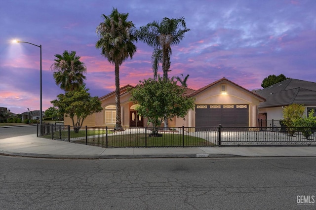 200 Justin Ct, Shafter, CA 93263 - view of front of property featuring a fenced front yard, a garage, concrete driveway, stucco siding, and a tiled roof