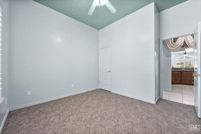 200 Justin Ct, Shafter, CA 93263 - unfurnished bedroom featuring light carpet, ensuite bath, and ceiling fan