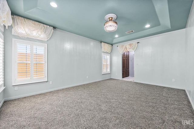 200 Justin Ct, Shafter, CA 93263 - empty room with a raised ceiling, carpet flooring, recessed lighting, and plenty of natural light