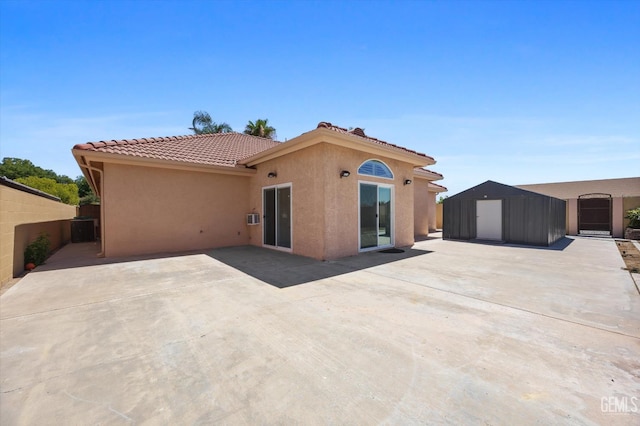 200 Justin Ct, Shafter, CA 93263 - rear view of house featuring stucco siding, a shed, a patio, and a tile roof