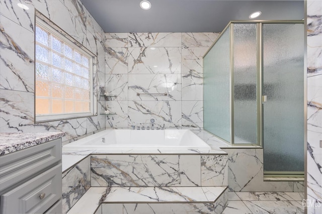200 Justin Ct, Shafter, CA 93263 - full bathroom featuring marble tiled flooring, a garden tub, tile walls, recessed lighting, and vanity