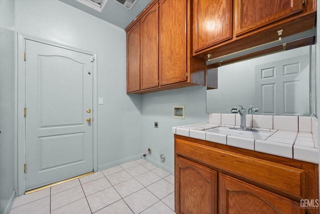 200 Justin Ct, Shafter, CA 93263 - laundry room featuring hookup for an electric dryer, gas dryer hookup, cabinet space, washer hookup, and light tile patterned floors