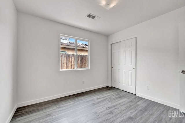 313 Mission St, Mc Farland, CA 93250 - unfurnished bedroom with wood finished floors, baseboards, and a closet