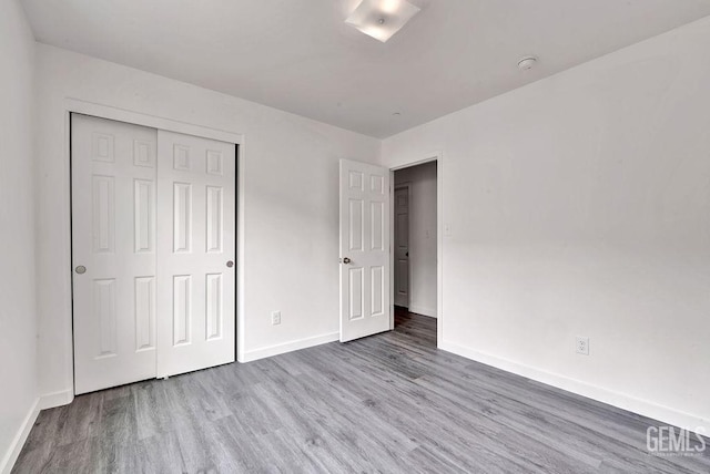 313 Mission St, Mc Farland, CA 93250 - unfurnished bedroom featuring baseboards, a closet, and wood finished floors