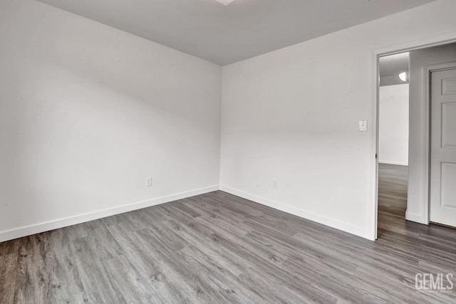 313 Mission St, Mc Farland, CA 93250 - empty room with wood finished floors and baseboards
