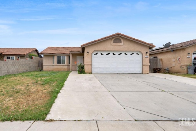 313 Mission St, Mc Farland, CA 93250 - ranch-style house with fence, a garage, stucco siding, concrete driveway, and a tiled roof