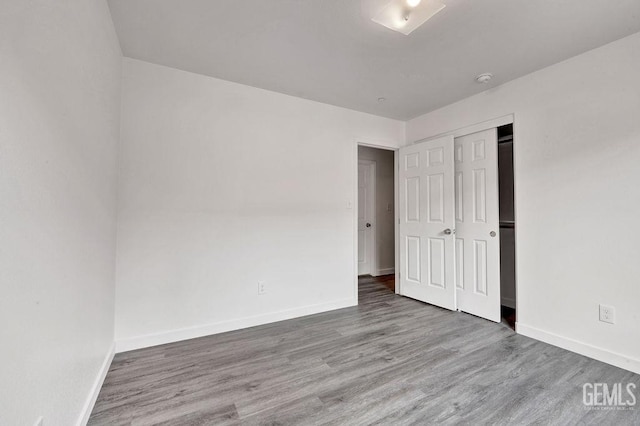 313 Mission St, Mc Farland, CA 93250 - unfurnished bedroom featuring baseboards, wood finished floors, and a closet