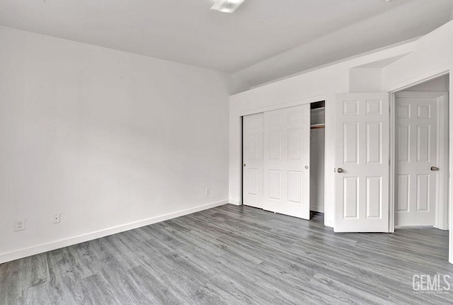 313 Mission St, Mc Farland, CA 93250 - unfurnished bedroom with baseboards, lofted ceiling, wood finished floors, and a closet