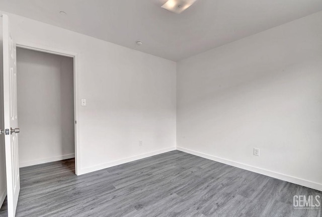 313 Mission St, Mc Farland, CA 93250 - empty room featuring baseboards and wood finished floors