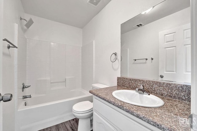 313 Mission St, Mc Farland, CA 93250 - bathroom with vanity, toilet, wood finished floors, and shower / bathtub combination