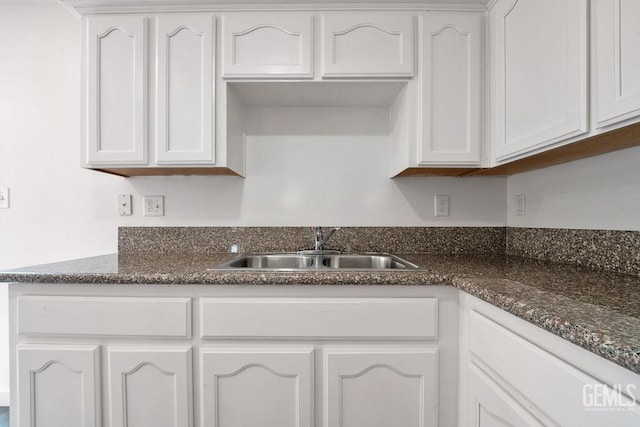 313 Mission St, Mc Farland, CA 93250 - kitchen with dark stone counters, white cabinetry, and a sink