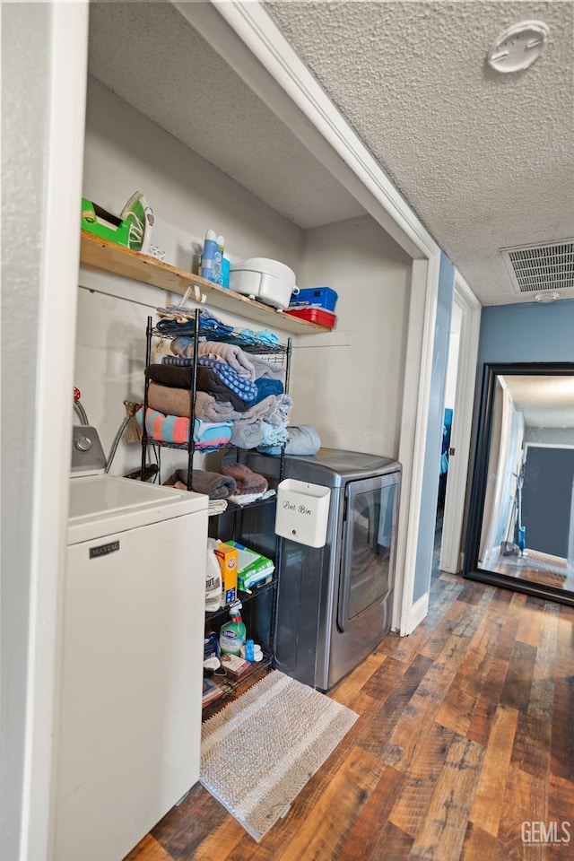 262 Olson Ave, Shafter, CA 93263 - laundry area with hardwood / wood-style flooring, a textured ceiling, and washing machine and dryer