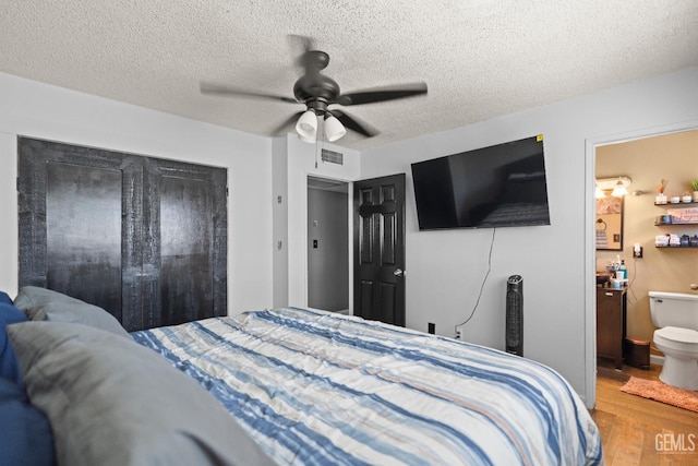 262 Olson Ave, Shafter, CA 93263 - bedroom featuring wood finished floors, a textured ceiling, a ceiling fan, and ensuite bathroom