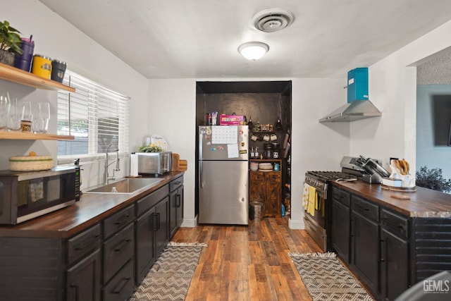 262 Olson Ave, Shafter, CA 93263 - kitchen with appliances with stainless steel finishes, butcher block counters, wood finished floors, and open shelves