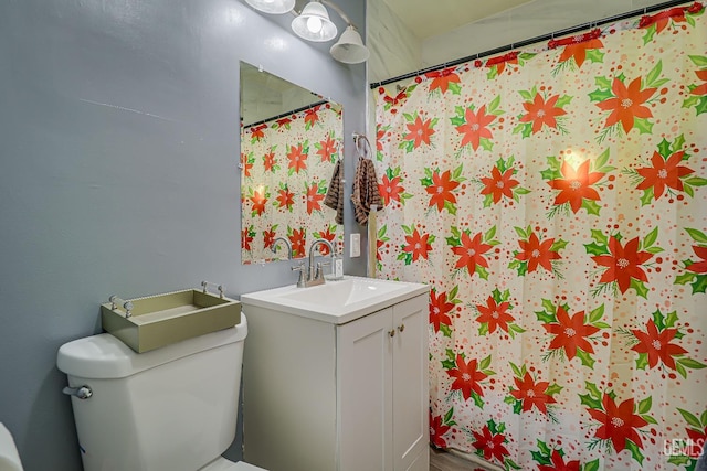 bathroom featuring walk in shower, vanity, and toilet