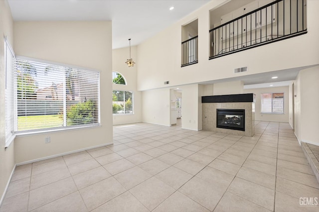 6209 Ambergrove St, Bakersfield, CA 93313 - unfurnished living room with light tile patterned flooring, a tiled fireplace, high vaulted ceiling, and recessed lighting