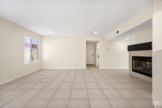 6209 Ambergrove St, Bakersfield, CA 93313 - unfurnished living room with a tiled fireplace, recessed lighting, and light tile patterned flooring
