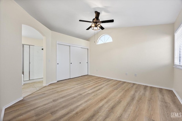 6209 Ambergrove St, Bakersfield, CA 93313 - unfurnished bedroom with lofted ceiling, light wood-style flooring, arched walkways, and a ceiling fan