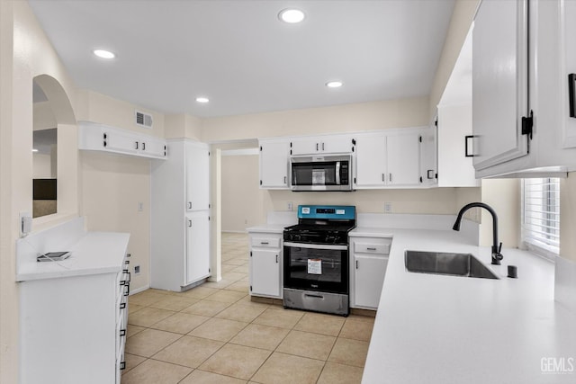 6209 Ambergrove St, Bakersfield, CA 93313 - kitchen featuring stainless steel appliances, light tile patterned floors, light countertops, white cabinetry, and recessed lighting