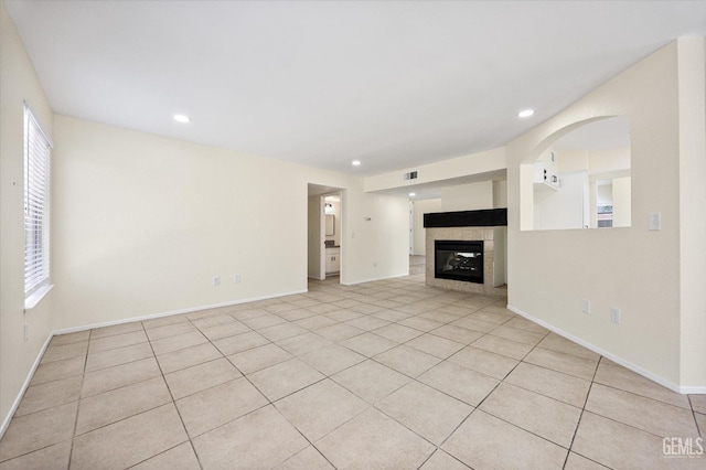 6209 Ambergrove St, Bakersfield, CA 93313 - unfurnished living room featuring a fireplace, plenty of natural light, light tile patterned floors, and recessed lighting