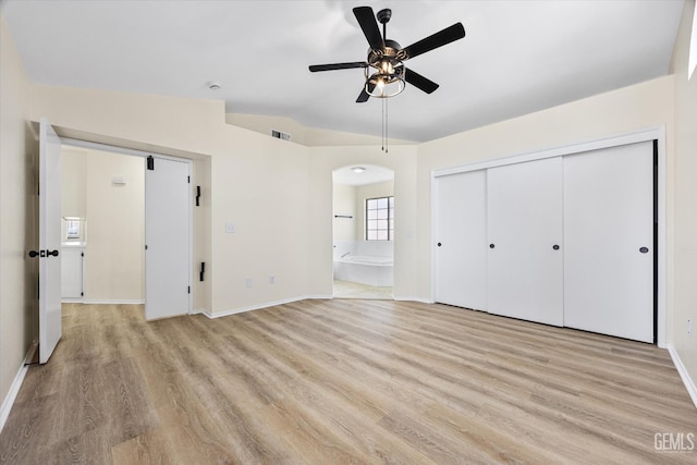 6209 Ambergrove St, Bakersfield, CA 93313 - unfurnished bedroom with light wood-style floors, arched walkways, ensuite bath, a closet, and ceiling fan