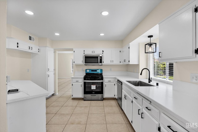 6209 Ambergrove St, Bakersfield, CA 93313 - kitchen featuring appliances with stainless steel finishes, white cabinetry, light tile patterned floors, recessed lighting, and light countertops