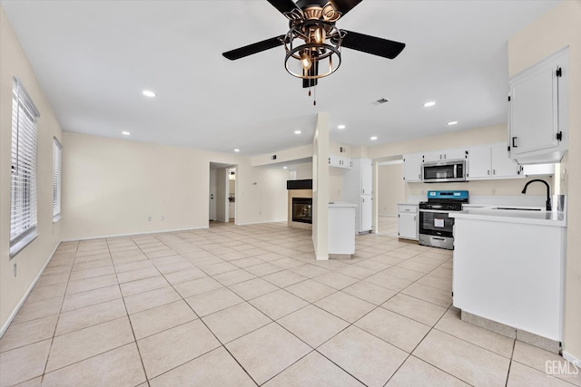 6209 Ambergrove St, Bakersfield, CA 93313 - kitchen featuring stainless steel appliances, a ceiling fan, open floor plan, light countertops, and white cabinets