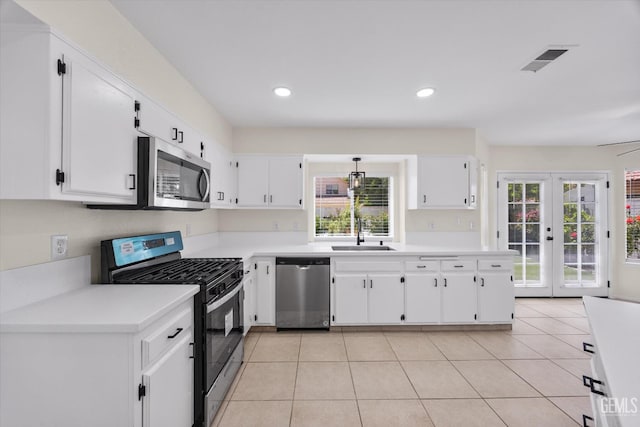 6209 Ambergrove St, Bakersfield, CA 93313 - kitchen featuring stainless steel appliances, plenty of natural light, white cabinetry, light countertops, and recessed lighting