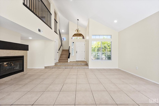 6209 Ambergrove St, Bakersfield, CA 93313 - foyer entrance with a fireplace, high vaulted ceiling, recessed lighting, light tile patterned floors, and stairway