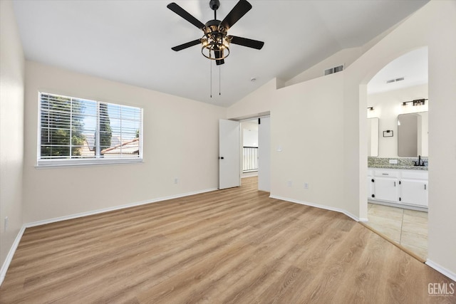 6209 Ambergrove St, Bakersfield, CA 93313 - unfurnished bedroom featuring light wood-style flooring, lofted ceiling, arched walkways, connected bathroom, and ceiling fan