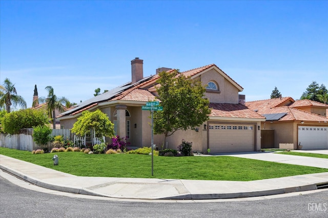 6209 Ambergrove St, Bakersfield, CA 93313 - mediterranean / spanish home with solar panels, stucco siding, driveway, a tile roof, and a chimney