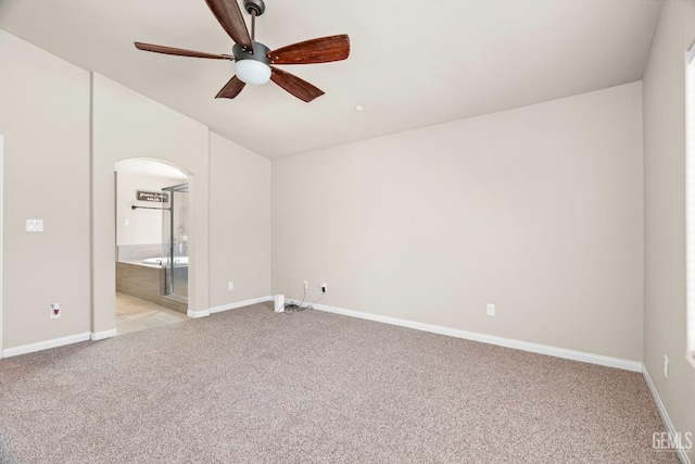 15020 Cotton Blossom Ave, Bakersfield, CA 93314 - unfurnished bedroom with light carpet, arched walkways, vaulted ceiling, baseboards, and connected bathroom