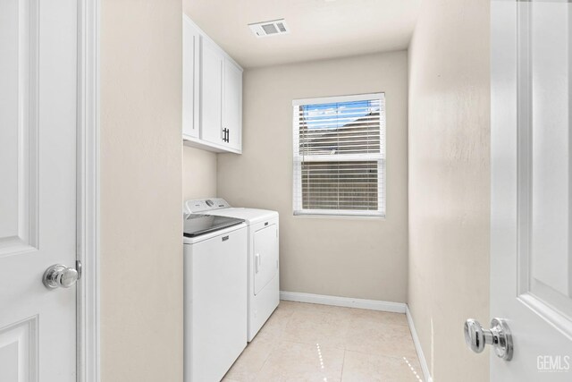 15020 Cotton Blossom Ave, Bakersfield, CA 93314 - washroom featuring washing machine and dryer, cabinet space, baseboards, and light tile patterned flooring