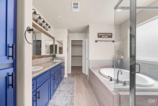 15020 Cotton Blossom Ave, Bakersfield, CA 93314 - full bath featuring double vanity, a walk in closet, a bath, and baseboards