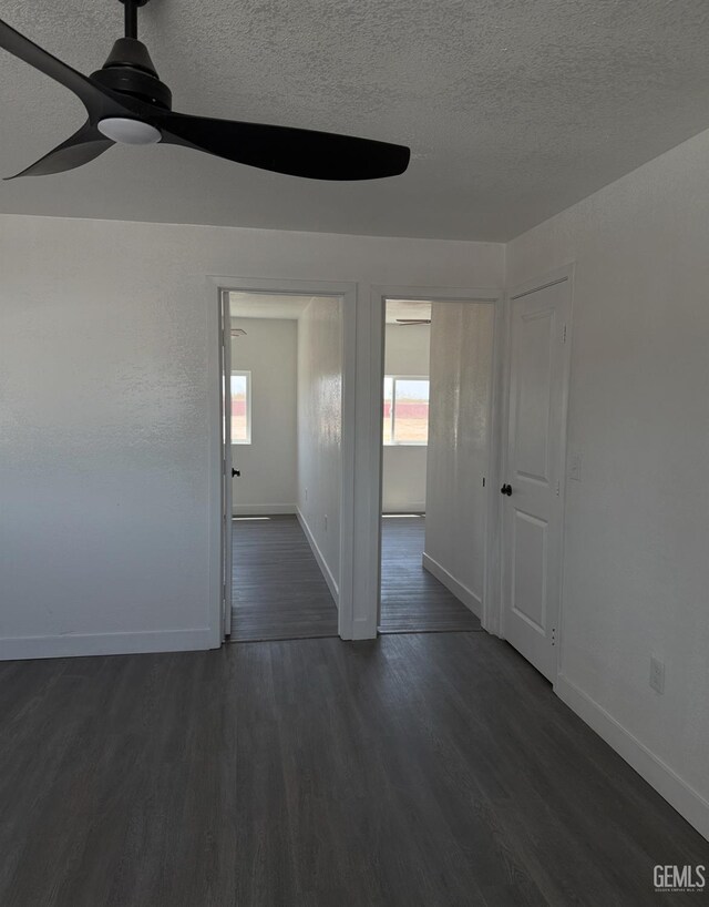28112 Pond Rd, Wasco, CA 93280 - empty room featuring ceiling fan, plenty of natural light, a textured ceiling, and dark wood-type flooring
