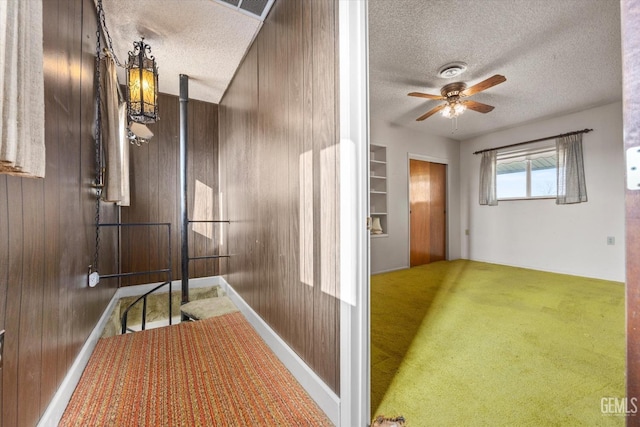 13754 Rosedale Hwy, Bakersfield, CA 93314 - hallway with wooden walls, a textured ceiling, and carpet