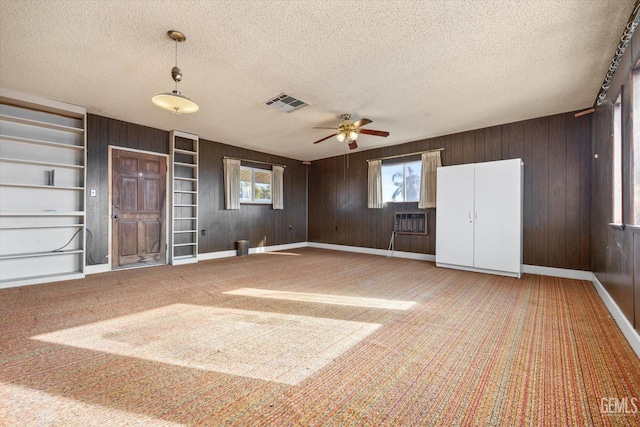 13754 Rosedale Hwy, Bakersfield, CA 93314 - interior space with a wall mounted air conditioner, carpet floors, wooden walls, and a textured ceiling