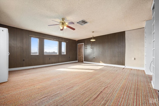 13754 Rosedale Hwy, Bakersfield, CA 93314 - carpeted spare room with ceiling fan, wooden walls, and a textured ceiling