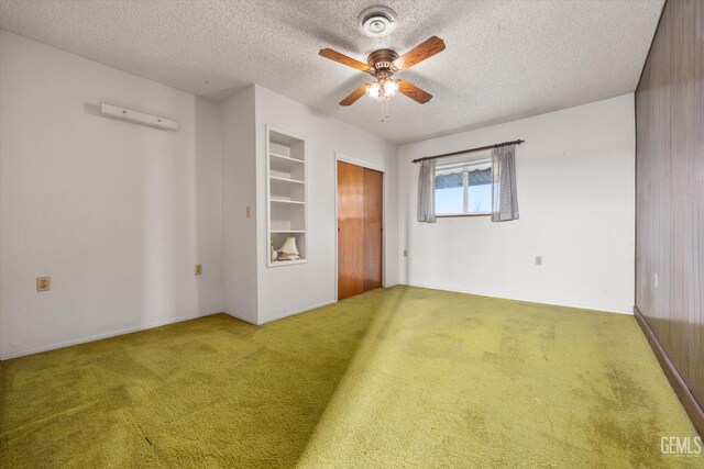 13754 Rosedale Hwy, Bakersfield, CA 93314 - spare room featuring built in shelves, ceiling fan, carpet floors, and a textured ceiling