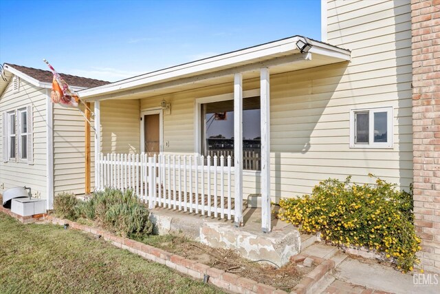 view of exterior entry featuring a porch