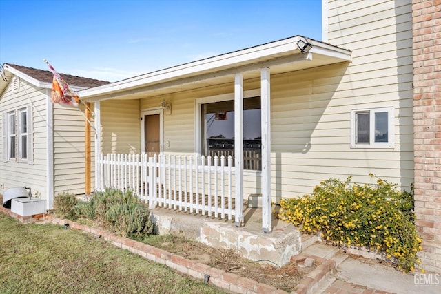 view of exterior entry featuring a porch