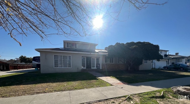 view of front of house with a garage and a front yard