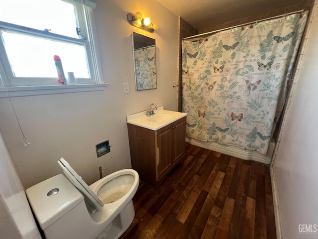 bathroom with wood-type flooring, vanity, toilet, and walk in shower