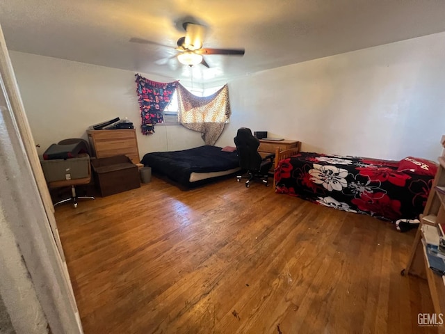 bedroom with ceiling fan and wood-type flooring